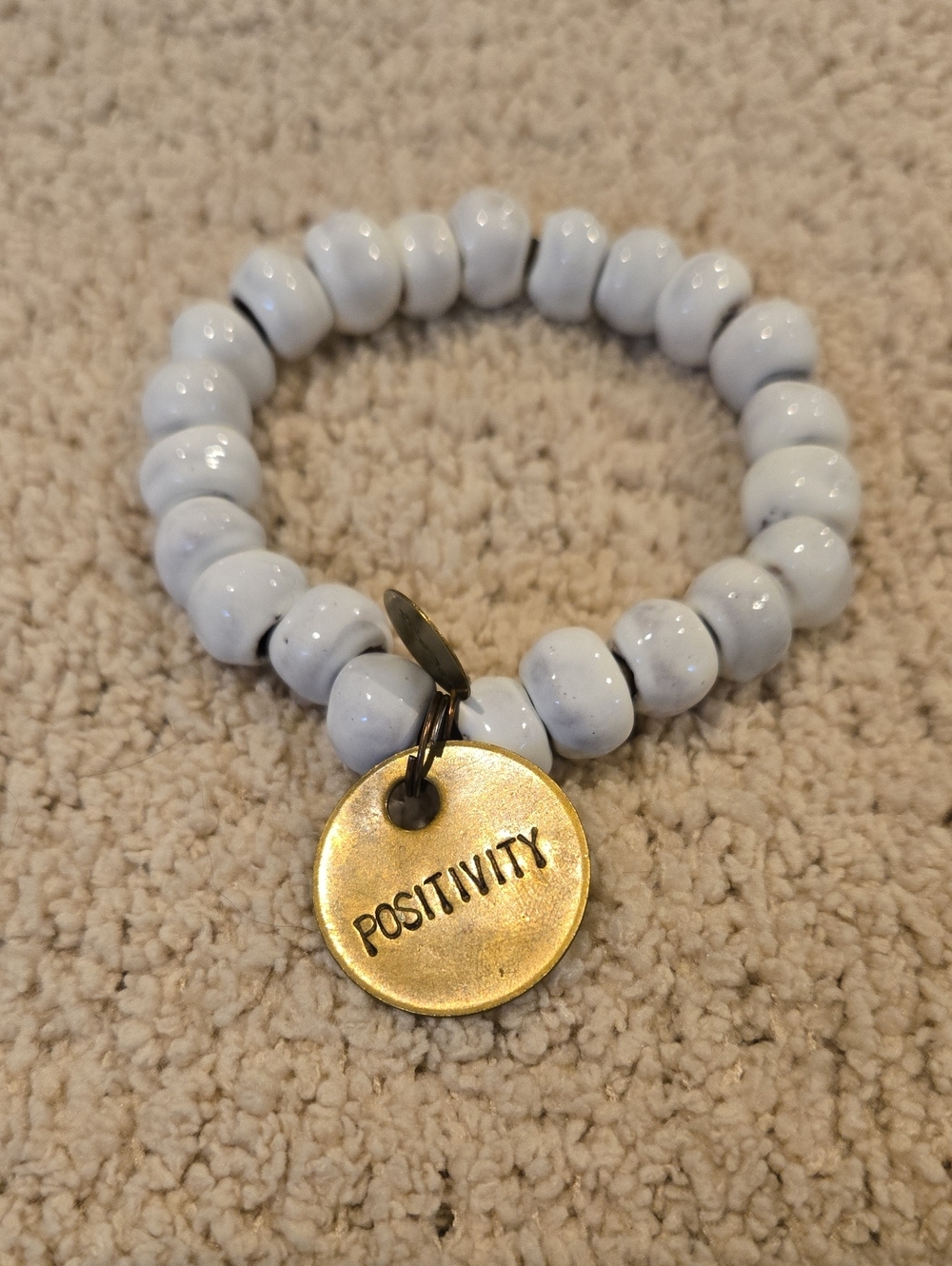 Positivity White Beaded Charm Bracelet - Gold Tone Tag